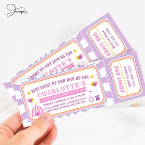 May include: Baby shower tickets with a circus theme. The tickets are pink, purple, and white, with text that reads "Step Right Up and Join Us for Charlotte's Incredible Baby Shower." Includes balloons, a circus tent, and a magician's hat.