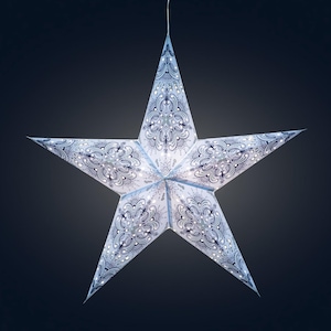 May include: A large, five-pointed star-shaped paper lantern. The star is white with a blue paisley pattern and small white lights. The lantern is hanging against a dark background, creating a festive and decorative appearance.