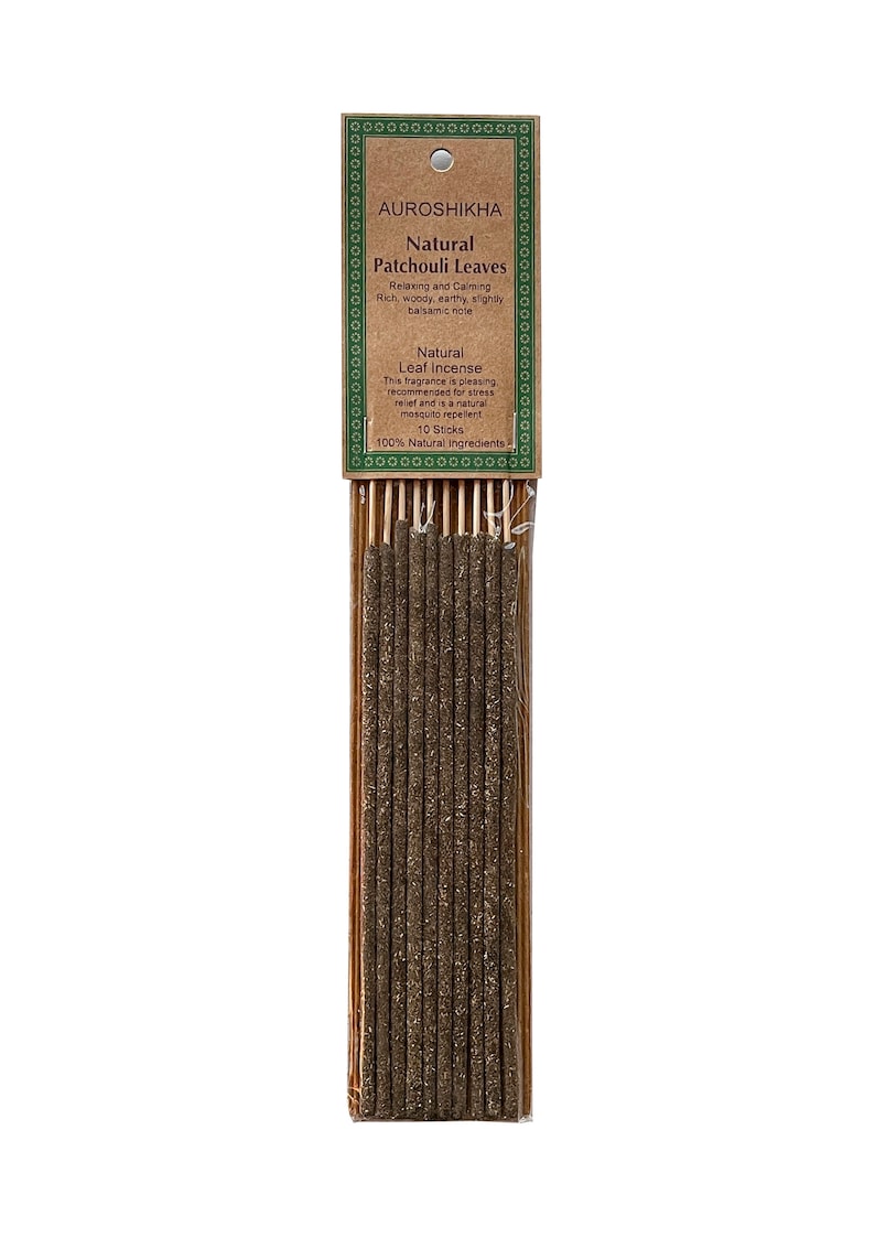 May include: A pack of 10 natural patchouli leaf incense sticks. The packaging is brown with green text that reads "AUROSHIKHA Natural Patchouli Leaves Relaxing and Calming Rich, woody, earthy, slightly balsamic note Natural Leaf Incense This fragrance is pleasing recommended for stress relief and is a natural mosquito repellent 10 Sticks 100% Natural ingredients".