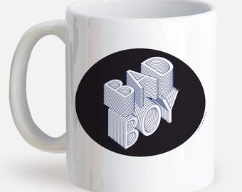 May include: White ceramic mug with a black circle containing the text "BAD BOY" in a white 3D-style font.
