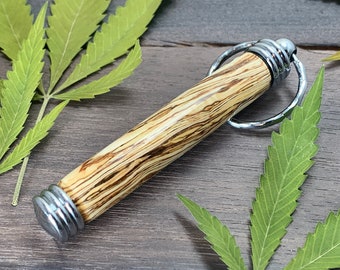 Handmade hidden compartment keychain/joint holder made with real hemp wood.