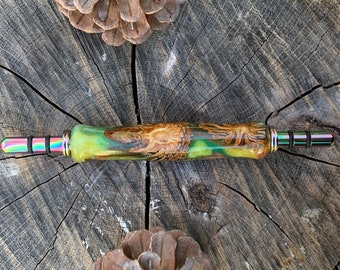 Seam ripper / stiletto combination. Handmade handle made with real pine cones cast in yellow, green, and red resin.