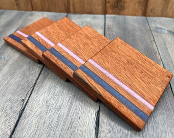 Set of 4 coasters cut from a single piece of sapele wood, with blue and purple resin inlays.