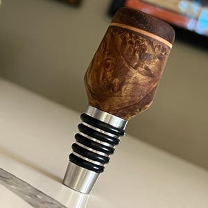 Handmade wood turned bottle stopper a food grade stainless steel base. Multiple wood options available