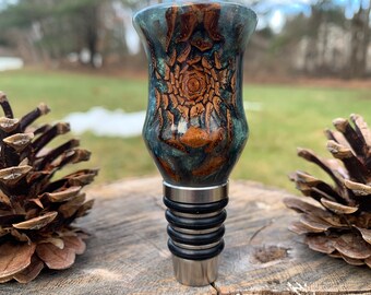 Handmade green and pearlescent blue resin bottle stopper with real pine cone and stainless steel hardware
