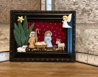 Mini Nativity in 3”x4” black frame.