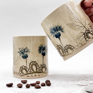Green and blue flower ceramic mug with vintage lace imprint and bachelor button, leaf imprints; NC clay pottery coffee cup