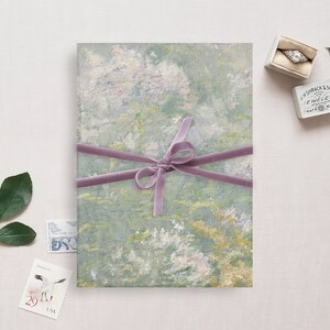 May include: A green and white abstract art print with a purple ribbon tied around it. The print is on a white background.