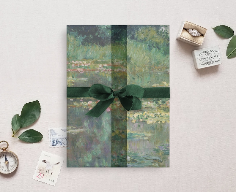 May include: A green and blue painting of water lilies is wrapped in green paper with a green ribbon. The painting is tied with a green ribbon and bow. The painting is on a white background.