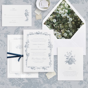 May include: A wedding invitation suite with a floral design. The invitation card features a blue floral border and the text "Emma Isabella & Jonathan Williams". The RSVP card features a blue floral design and the text "RSVP by February 1". The details card features a blue floral design and the text "The Details".