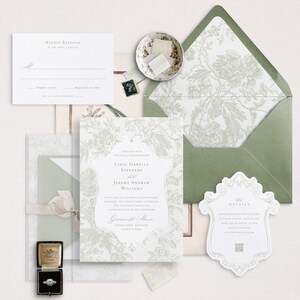 May include: A white wedding invitation with a floral design and the text "India Isabella Stephens and Jeremy Andrew Williams" in a grey font. The invitation is on a white background with a green envelope and a small white detail card.