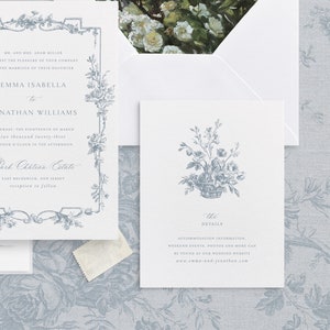 May include: A wedding invitation with a floral border and a basket of flowers. The invitation is for Emma Isabella and Jonathan Williams, and it is set for Saturday, March 18th, 2023 at 4:00 PM at Part Chateau Estate in East Brunswick, New Jersey. The invitation also includes a separate card with details about the wedding, including accommodation information, weekend events, photos, and more.