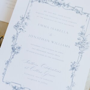 May include: A wedding invitation with a blue floral border. The invitation reads "Mr. and Mrs. Adam Miller request the pleasure of your company at the marriage of their daughter Emma Isabella to Jonathan Williams Saturday, the fifteen of April two thousand twenty-three at four o'clock in the afternoon Southern Celebrations at Collins Grove Florence, South Carolina reception to follow"