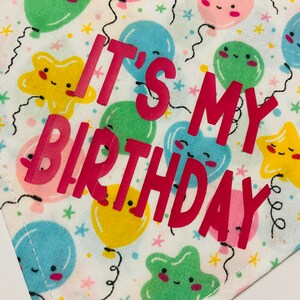 May include: White fabric with a colorful balloon pattern and the text "It's My Birthday" in pink letters.