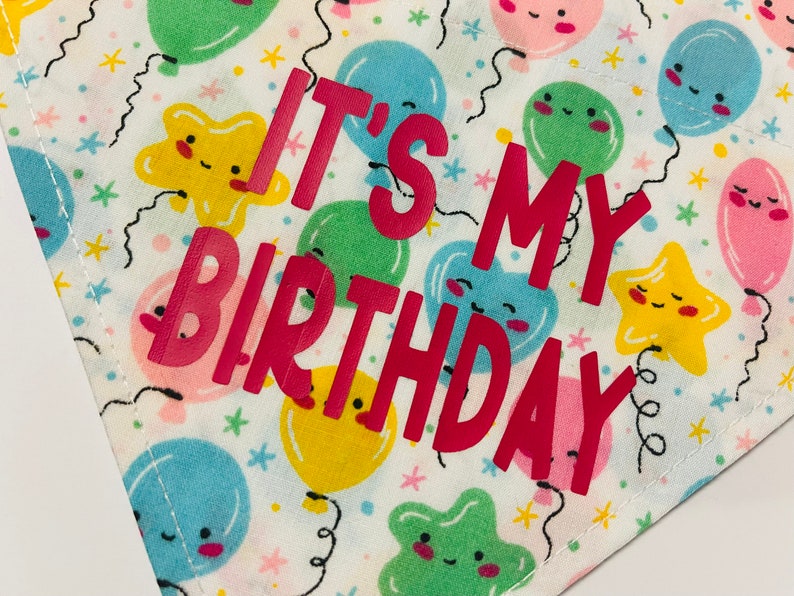 May include: White fabric with a colorful balloon pattern and the text "It's My Birthday" in pink letters.