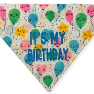 May include: White fabric dog bandana with a colorful balloon pattern and the text "It's My Birthday" in blue.