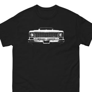 May include: A black t-shirt with a white silhouette of a classic pickup truck. The truck's front grille and headlights are visible.