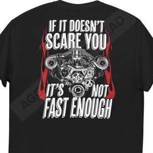 May include: Black t-shirt with a white graphic of a car engine with flames on either side. The text "If it doesn't scare you it's not fast enough" is printed on the shirt.
