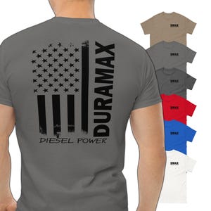 May include: A gray t-shirt with a black and white American flag design and the text "DURAMAX DIESEL POWER".