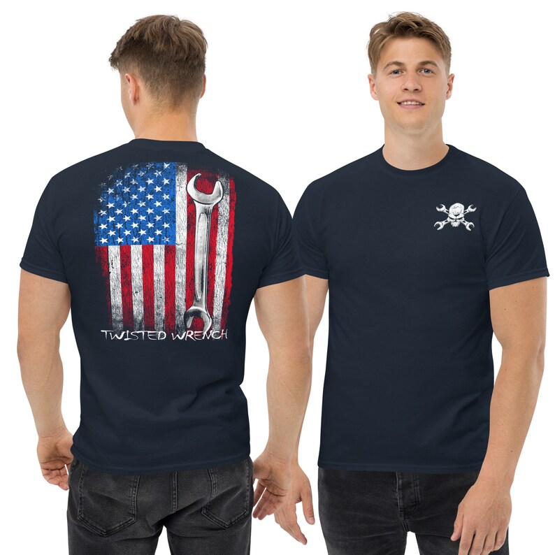 May include: A navy blue t-shirt with a distressed American flag design and a wrench on the back. The front of the shirt has a white skull and crossbones with wrenches design. The text "TWISTED WRENCH" is printed below the flag.