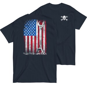 May include: Navy blue t-shirt with a distressed American flag design and a wrench. The back of the shirt has the text "TWISTED WRENCH". The front of the shirt has a skull and crossbones with wrenches.