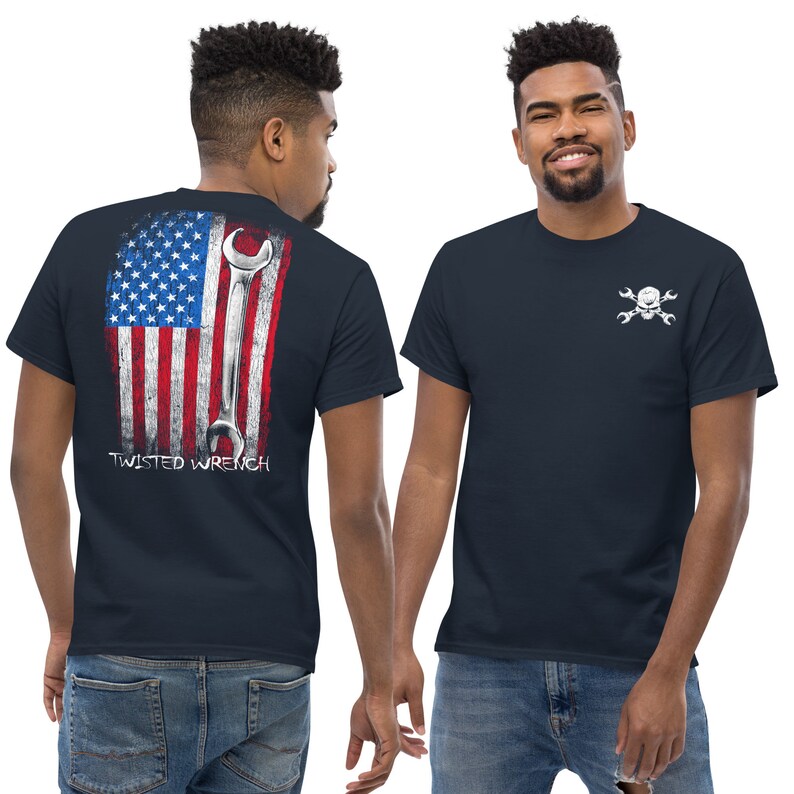 May include: A navy blue t-shirt with a white American flag and wrench graphic on the back. The front of the shirt has a white skull and crossbones with wrenches graphic. The text "TWISTED WRENCH" is printed below the graphic on the back.