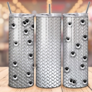 May include: Three stainless steel tumblers with a silver diamond plate pattern and bullet holes. The tumblers have lids and straws.