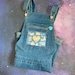 Relaxed boyfriend fit Ita overall denim overall shorts with enamel pin display clear window