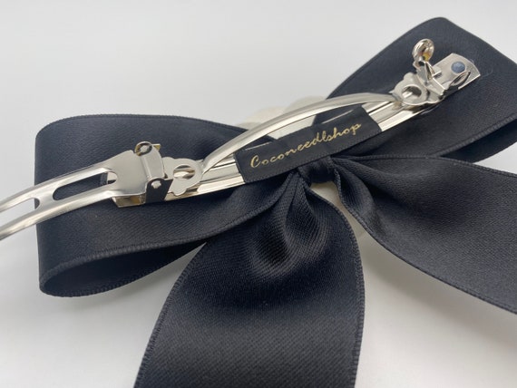 Sold at Auction: Two Chanel hair-bows with barrette clasps, 1980s
