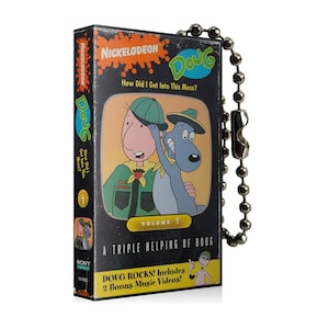 May include: A black and grey Doug VHS tape featuring the Nickelodeon logo and the title "How Did I Get Into This Mess?". The tape shows cartoon characters and text that reads "Volume 1" and "Doug Rocks! Includes 2 Bonus Music Videos!"