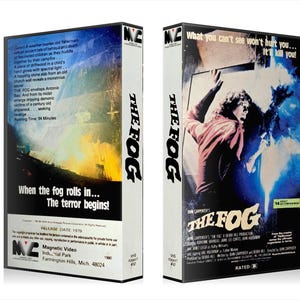K&ouml;nnte beinhalten: Zwei VHS-Videokassetten f&uuml;r den Horrorfilm "The Fog". Die Kassetten haben einen wei&szlig;en R&uuml;cken mit dem Filmtitel in Schwarz. Die Vorderseite zeigt eine Frau, die sich mit einem blau-wei&szlig;en Hintergrund ausstreckt. Die R&uuml;ckseite hat Text.