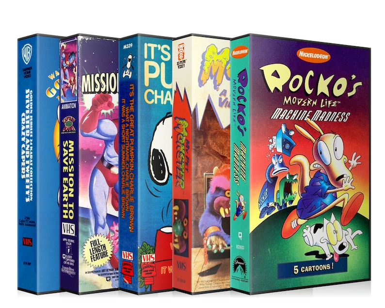 May include: A selection of retro VHS tapes showcasing animated cartoons. Titles include "Sylvester and Tweety's Crazy Capers," "Mission to Save Earth," "It's the Great Pumpkin, Charlie Brown," "Monster," and "Rocko's Modern Life: Machine Madness."
