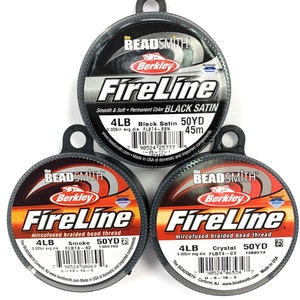 May include: Three spools of Berkley FireLine fishing line. The spools are black with red and white text. The line is available in Black Satin, Smoke, and Crystal. Each spool is labeled with the line's weight, diameter, and length. The text on the spools reads: "The Beadsmith", "Berkley", "FireLine", "mircofused braided bead thread", "4LB", "0.005in avg. dia", "Black Satin", "FLBT4-BSN", "50YD", "45m", "Smoke", "FLBT4-42", "1389709", "Crystal", "FLBT4-CY", "1389514", "Made in USA of domestic and imported components."