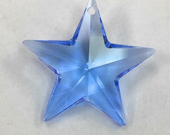 May include: A light blue crystal star charm with a hole at the top for hanging.