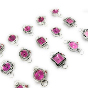 May include: Assortment of silver-toned wristwatches with pink faces. The watches have different shaped cases and are arranged in a row on a white background.