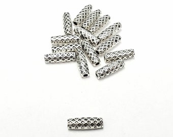 May include: A group of silver metal beads with a diamond pattern. The beads are cylindrical and have a slightly rounded shape.