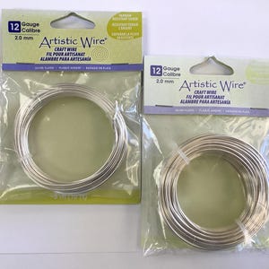 May include: Two packages of silver-plated craft wire, each containing 5 meters of 12 gauge wire. The packaging features the Artistic Wire logo and product details.