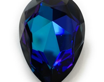 May include: A teardrop-shaped blue crystal with a faceted design.