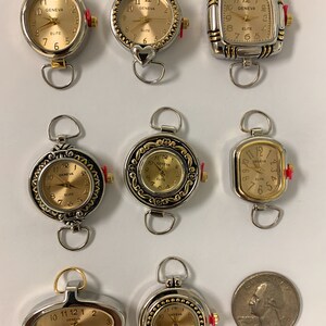 May include: Ten silver and gold tone wristwatches with round, square, and oval faces. The watches have a gold tone trim and say "Geneva Elite" on the face.