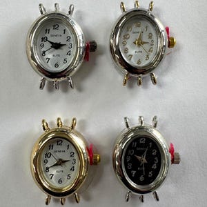 May include: Four oval-shaped watch faces with silver and gold-toned metal cases. Each watch face has a white or black dial with black numerals and hands. The watch faces are labeled "GENEVA ELITE".