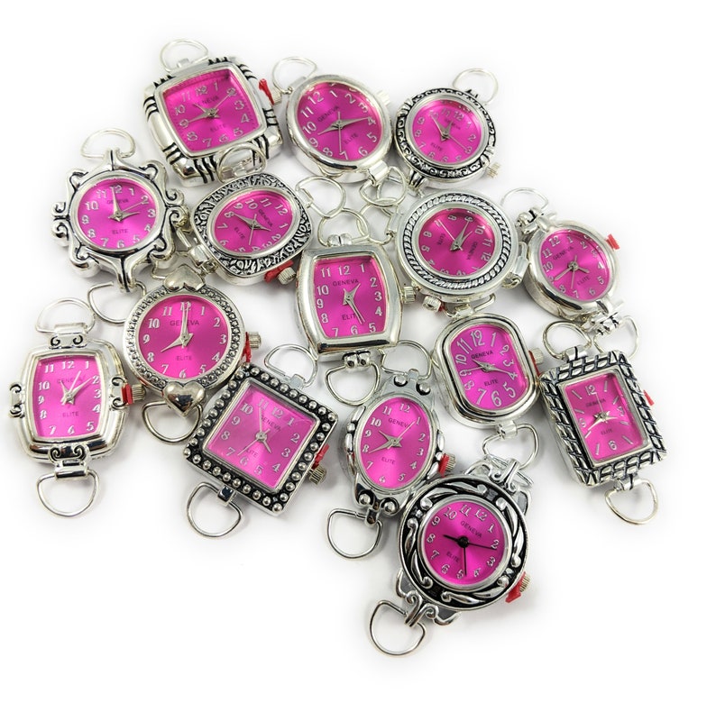 May include: A collection of 15 silver-tone wristwatches with pink faces. The watches have different styles of cases and bands.
