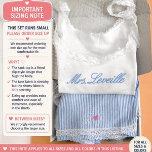 May include: A white tank top with lace trim and blue embroidered text reading Mrs. Leveille, paired with blue and white striped shorts featuring lace trim and pink embroidered initials. A sizing note box is included with text.