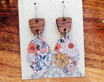 May include: A pair of floral print earrings with wooden accents. The earrings are on a white card with the text "The Girlz Fun Shop Etsy.com".