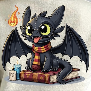 May include: A black dragon cartoon character wearing glasses and a scarf, sitting on a book. The dragon has large yellow eyes and its tongue is sticking out. A flame and two candles are also in the image.