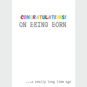 May include: A white card with the text "CONGRATULATIONS! ON BEING BORN... a really long time ago" in a colorful font.