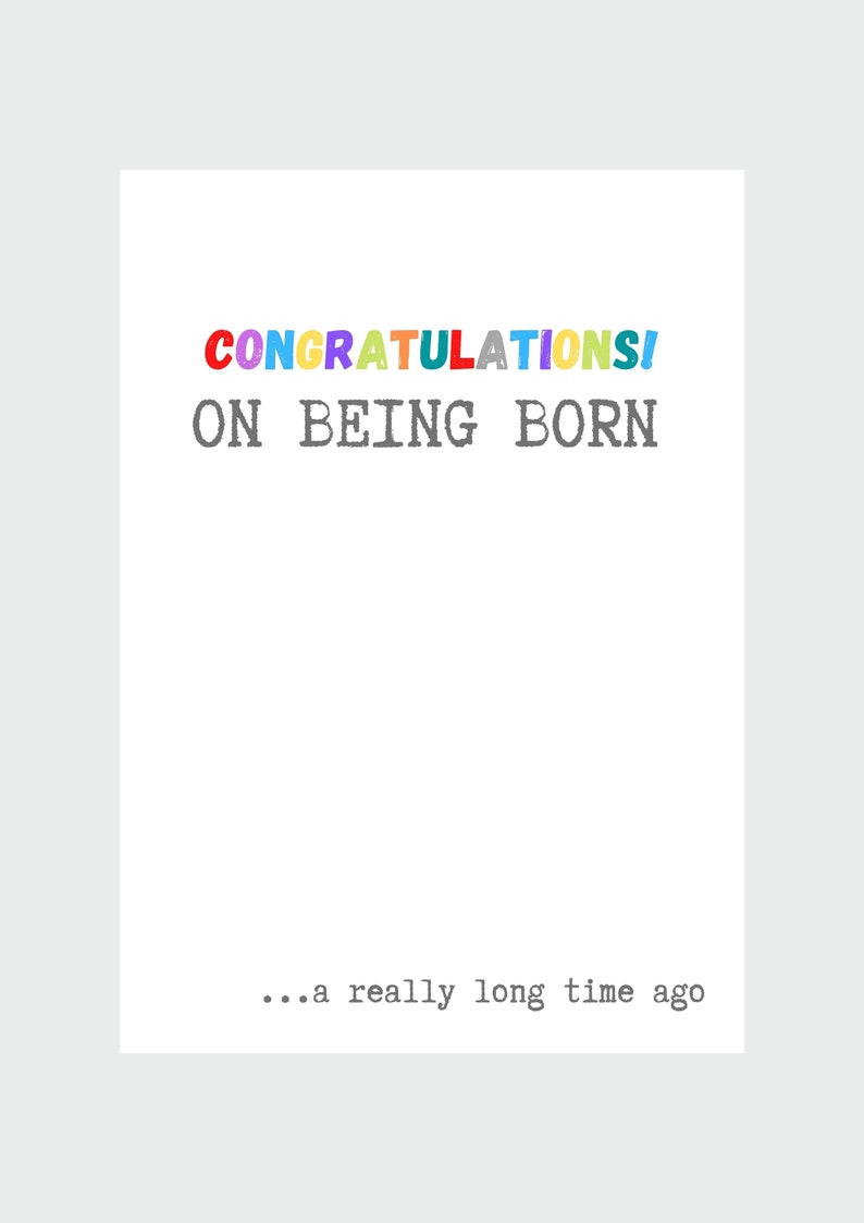 May include: A white card with the text "CONGRATULATIONS! ON BEING BORN... a really long time ago" in a colorful font.