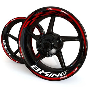 May include: Two black motorcycle wheels with red and white accents. The wheels have a multi-spoke design and feature the text "B-KING" in white. A red and black checkered pattern is visible on the rim.