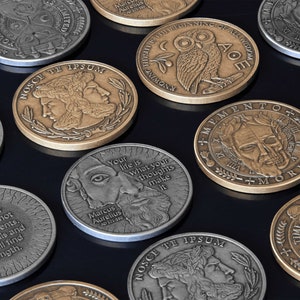 May include: A collection of round, metal coins with various designs and Latin phrases. The coins feature images of owls, skulls, and other figures. The coins are all bronze or silver in color.