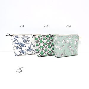 May include: Three rectangular zippered pouches labeled C12, C13, and C14. The first features a blue and white bird and floral pattern. The second has a green and black fan-shaped geometric design. The third is a light green pouch with white flowers.