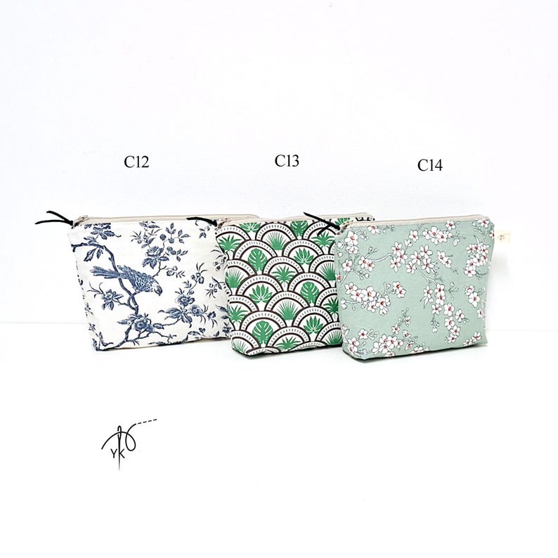May include: Three rectangular zippered pouches labeled C12, C13, and C14. The first features a blue and white bird and floral pattern. The second has a green and black fan-shaped geometric design. The third is a light green pouch with white flowers.